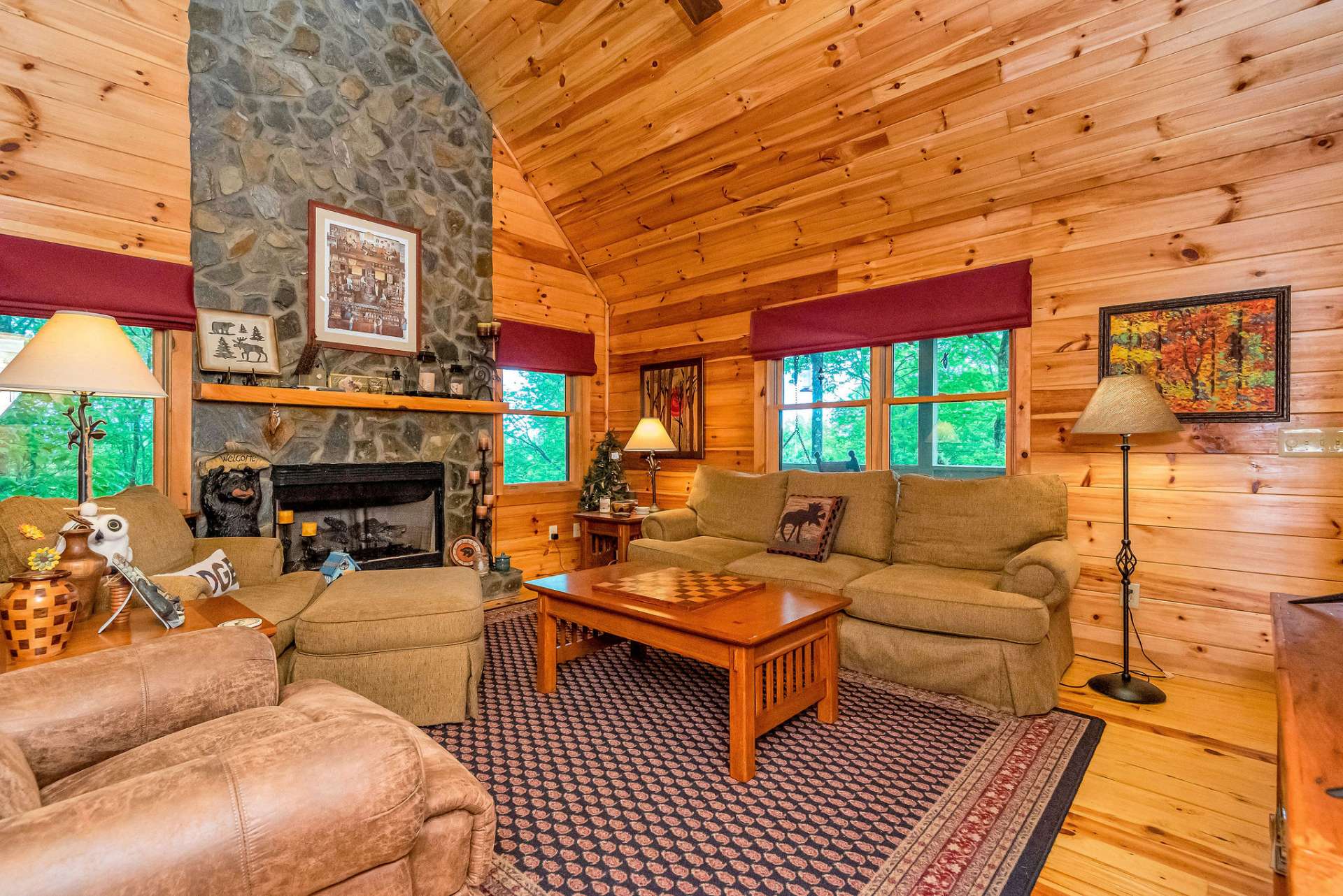The floor-to-ceiling fireplace commands attention as the focal point of the room.